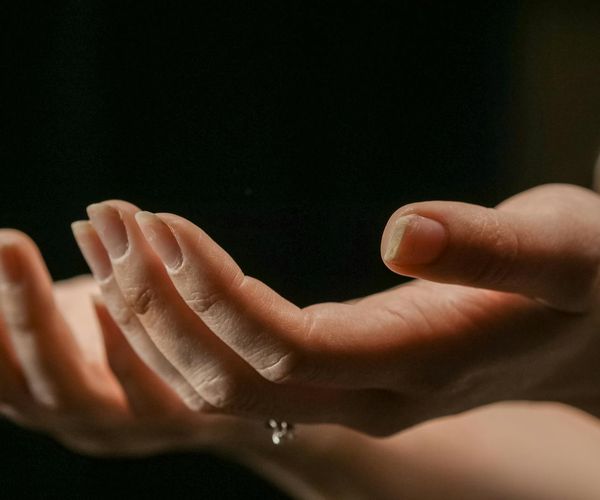 Close-up of hands cupped together, symbolizing warmth and gentle care.